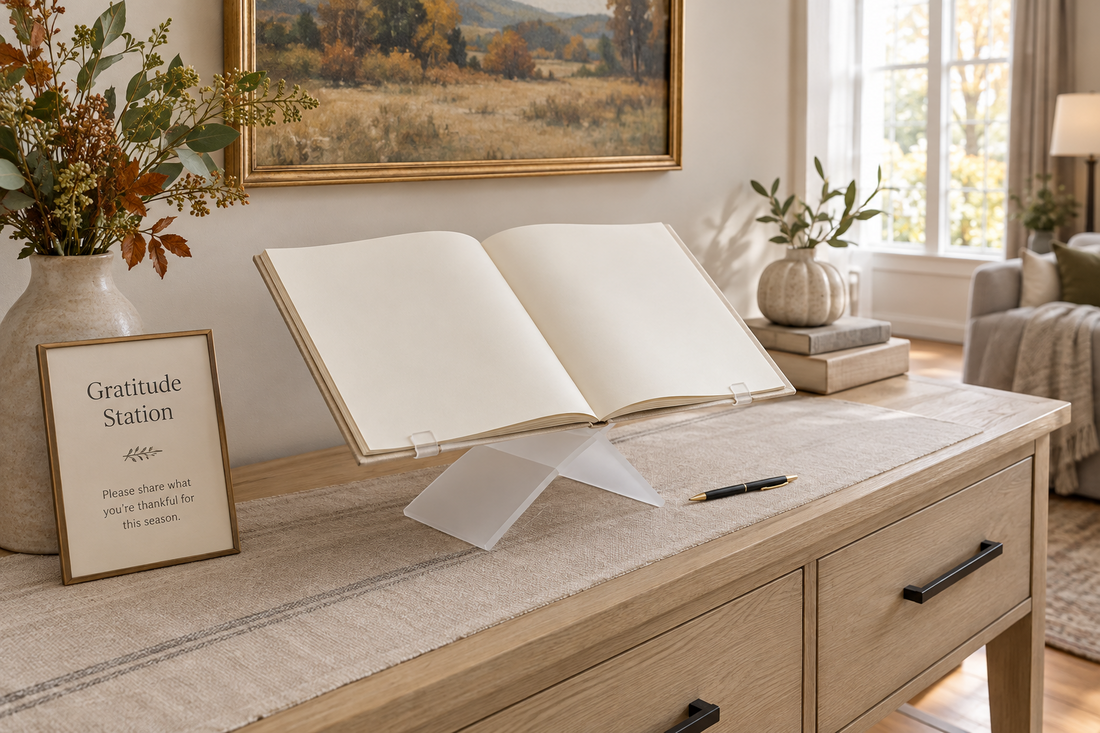 Open guest book on a white acrylic stand with a pen and clear writing space on an oak console for Thanksgiving.