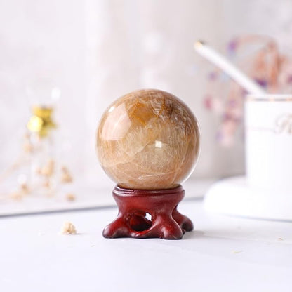 Nupuyai Natural Orange Moonstone Crystal Ball with Resin Stand, Healing Crystal Sphere for Home Decor 1.61"-1.97"(41mm-50mm)