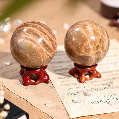 SUNYIK Natural Orange Moonstone Ball Sphere with Resin Stand Polished Crystal Sphere Stone Figurine Decor for Home Office Tabletop, 2-2.3"(51-60mm)