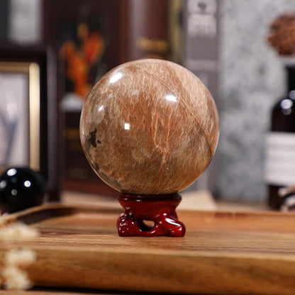 moonsix Natural Orange Moonstone Crystal Sphere with Resin Stand Healing Energy Stone Decorative Ball Sculpture for Home Office Tabletop, 71-80 mm