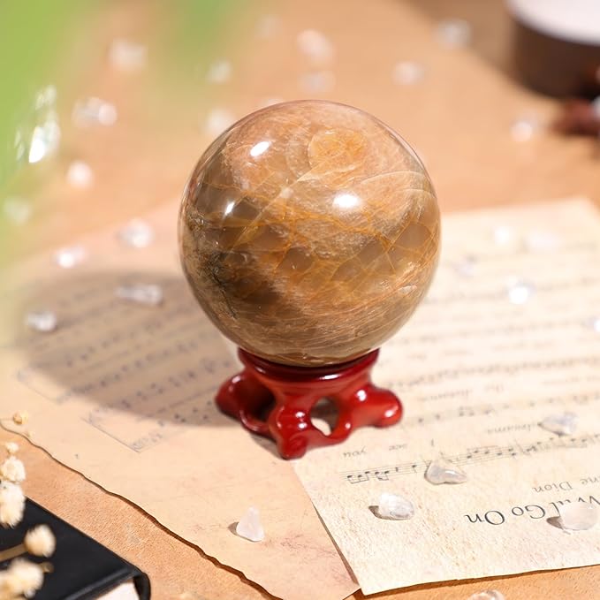 SUNYIK Natural Orange Moonstone Ball Sphere with Resin Stand Polished Crystal Sphere Stone Figurine Decor for Home Office Tabletop, 2.4-2.7”(61-70mm)